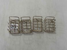 Set of four small silver five bar toast racks on ball feet, Sheffield 1916.