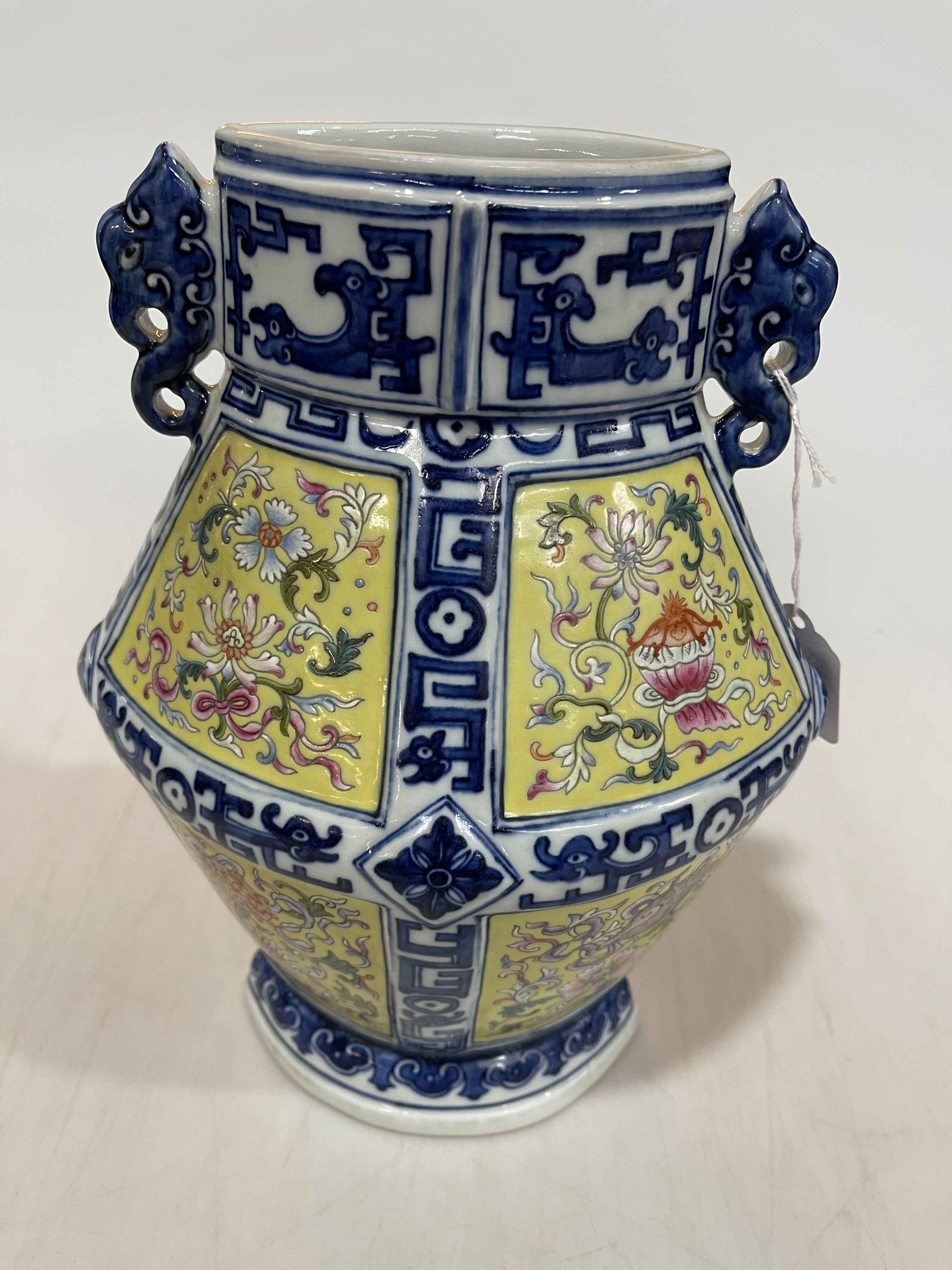 Good Chinese porcelain vase with famille rose on yellow panels and blue and white borders,