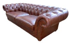 Brown deep buttoned leather and studded three seater Chesterfield settee, 244cm in length.