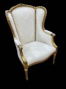 Giltwood arched wing back occasional armchair.