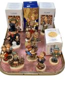 Collection of eleven Hummel figures, some with boxes.