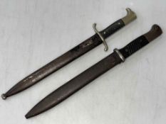 Two bayonets and scabbards.
