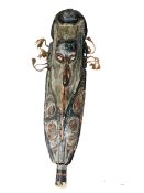 An ethnic carved wood wall mask, 110cm high.