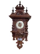 Victorian Continental walnut wall clock having enamelled and brass dial, 101cm.