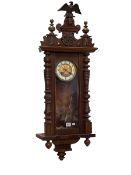 Victorian walnut Vienna style wall clock having enamelled and brass dial and pendulum decorated