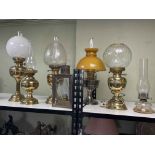 Collection of six oil lamps and one electric lamp, and a collection of oil lamp glass chimneys.