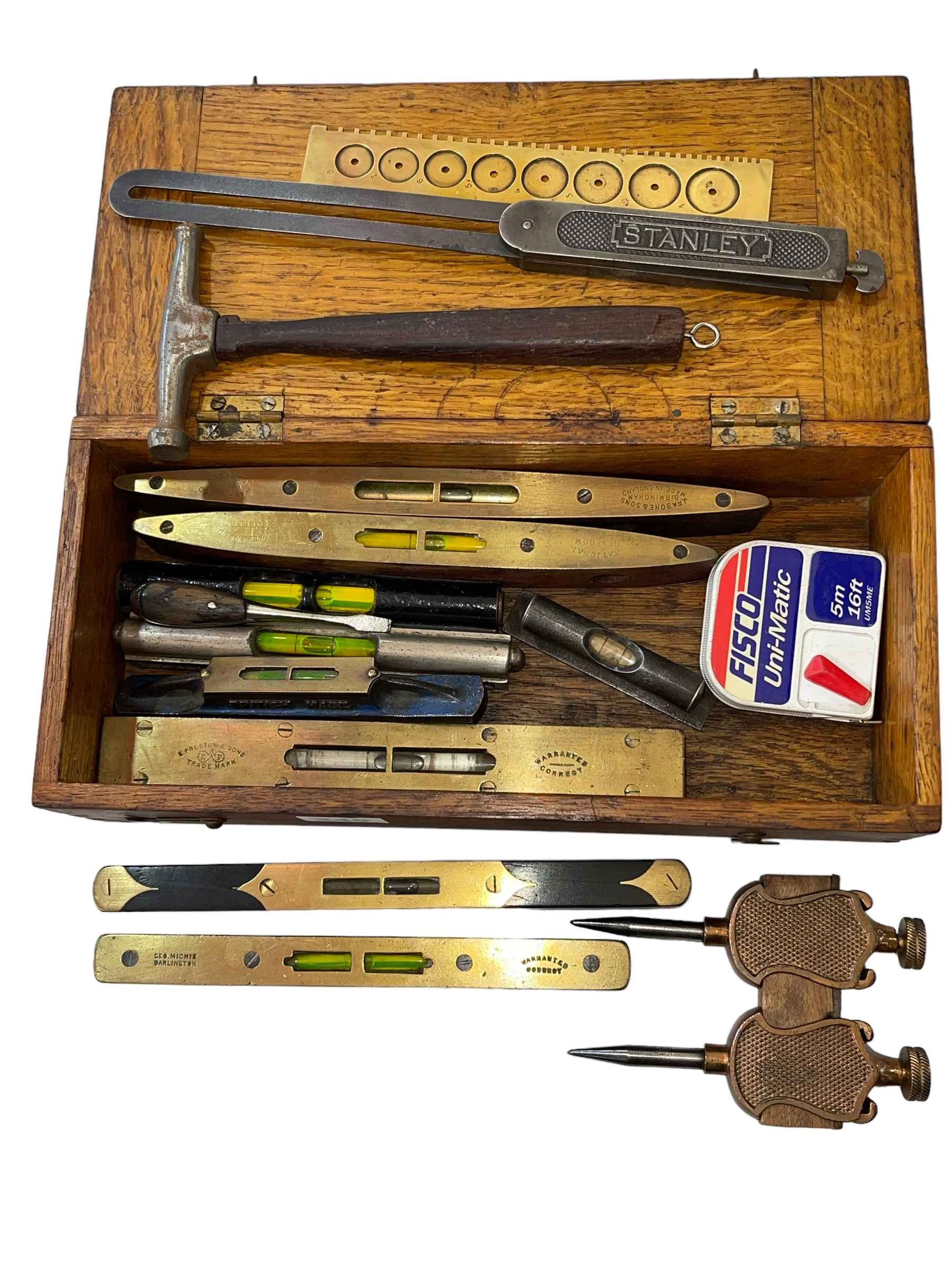 Oak box with vintage spirit levels, mainspring gauge, etc.