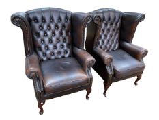 Pair Thomas Lloyd Brown buttoned and studded leather wing back armchairs.