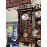 Victorian walnut Vienna style pendulum wall clock having enamelled and embossed dial and embossed