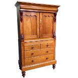 Victorian satin birch linen press having two panelled doors above two short and two long drawers on