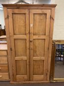 Stripped pine two door wardrobe, 194cm by 111cm by 59cm.