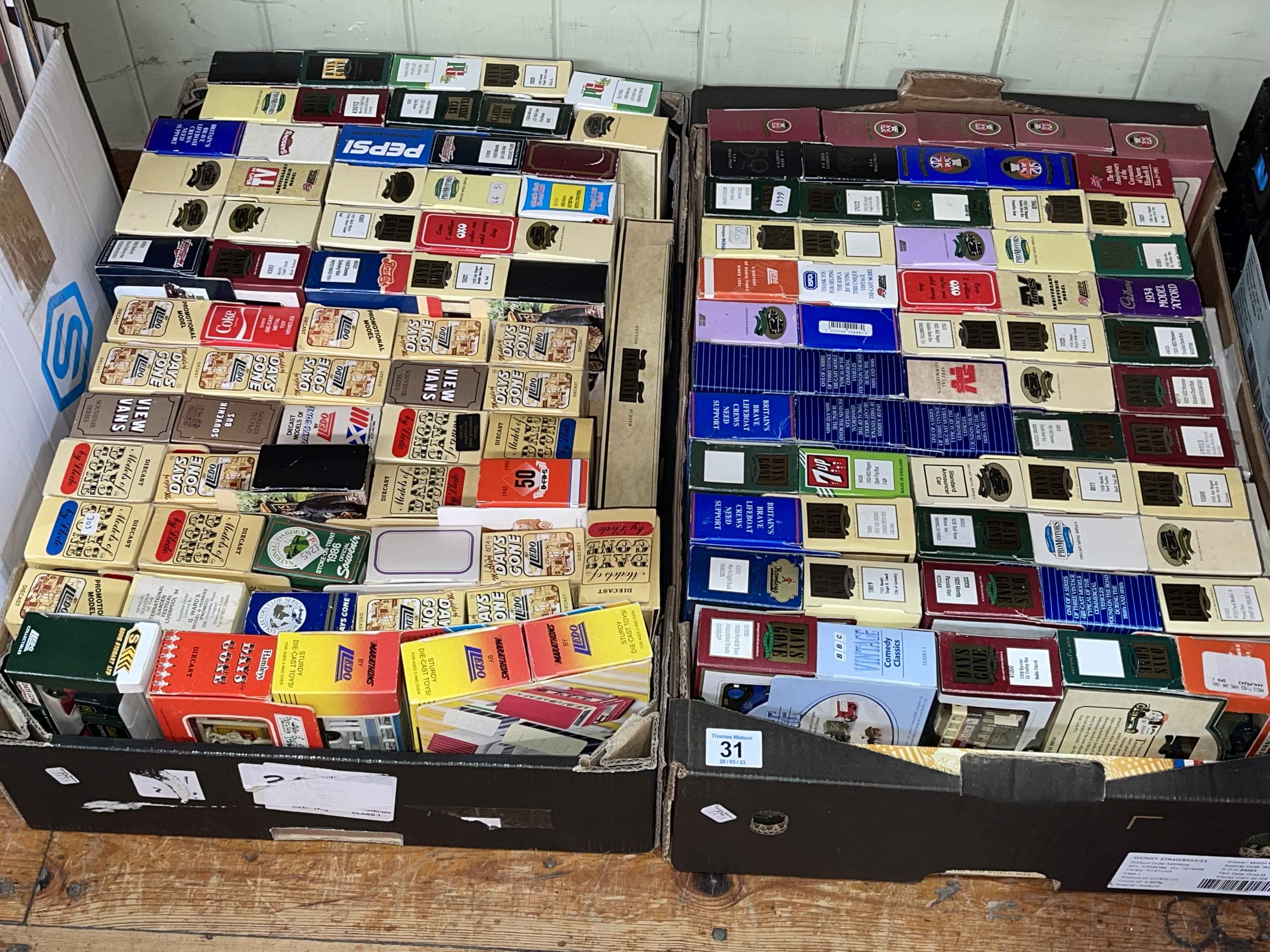 Two boxes of mostly Lledo model vehicles.