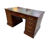 Mahogany nine drawer pedestal desk bearing label for Shoolbred & Co, 76.5cm by 137.5cm by 76cm.