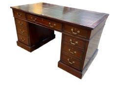 Mahogany nine drawer pedestal desk bearing label for Shoolbred & Co, 76.5cm by 137.5cm by 76cm.