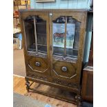 1920's/30's carved oak bookcase having two part glazed doors above two drawers,