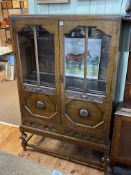 1920's/30's carved oak bookcase having two part glazed doors above two drawers,