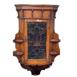 Early 20th Century oak corner wall cabinet having leaded coloured glass panel door and open side