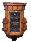 Early 20th Century oak corner wall cabinet having leaded coloured glass panel door and open side