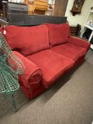 Contemporary two seater settee in red fabric.