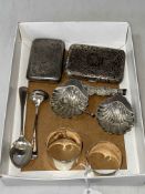 Silver items comprising two cigarette cases, shell salts, two napkin rings and two spoons.