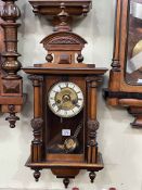 Small Victorian walnut and ebonised pendulum wall clock having enamelled and brass dial, 72cm.