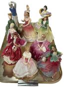 Collection of eleven Royal Doulton figures including The Golfer and Autumn Breeze.
