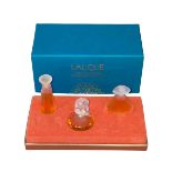 Boxed Lalique miniature scent bottles.