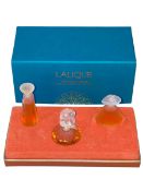 Boxed Lalique miniature scent bottles.