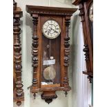 Victorian walnut double weight Vienna style wall clock having enamelled dial, 106cm.