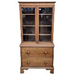 Mahogany bookcase having double glazed door top above a two drawer base on bracket feet, 155.