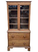 Mahogany bookcase having double glazed door top above a two drawer base on bracket feet, 155.