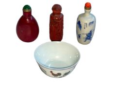 Chinese Cinnabar and two other opium bottles and small tea bowl decorated with chickens and flowers.