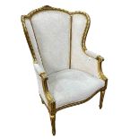 Giltwood arched wing back occasional armchair.