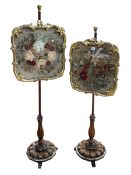 Pair Victorian rosewood and giltwood glazed needlework panel pole screens on triform base.