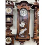 Victorian walnut and ebonised double weight Vienna style wall clock having enamelled dial, 108cm.