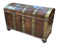 Large brass bound dome top trunk on bun feet, 76cm by 121cm by 63cm.