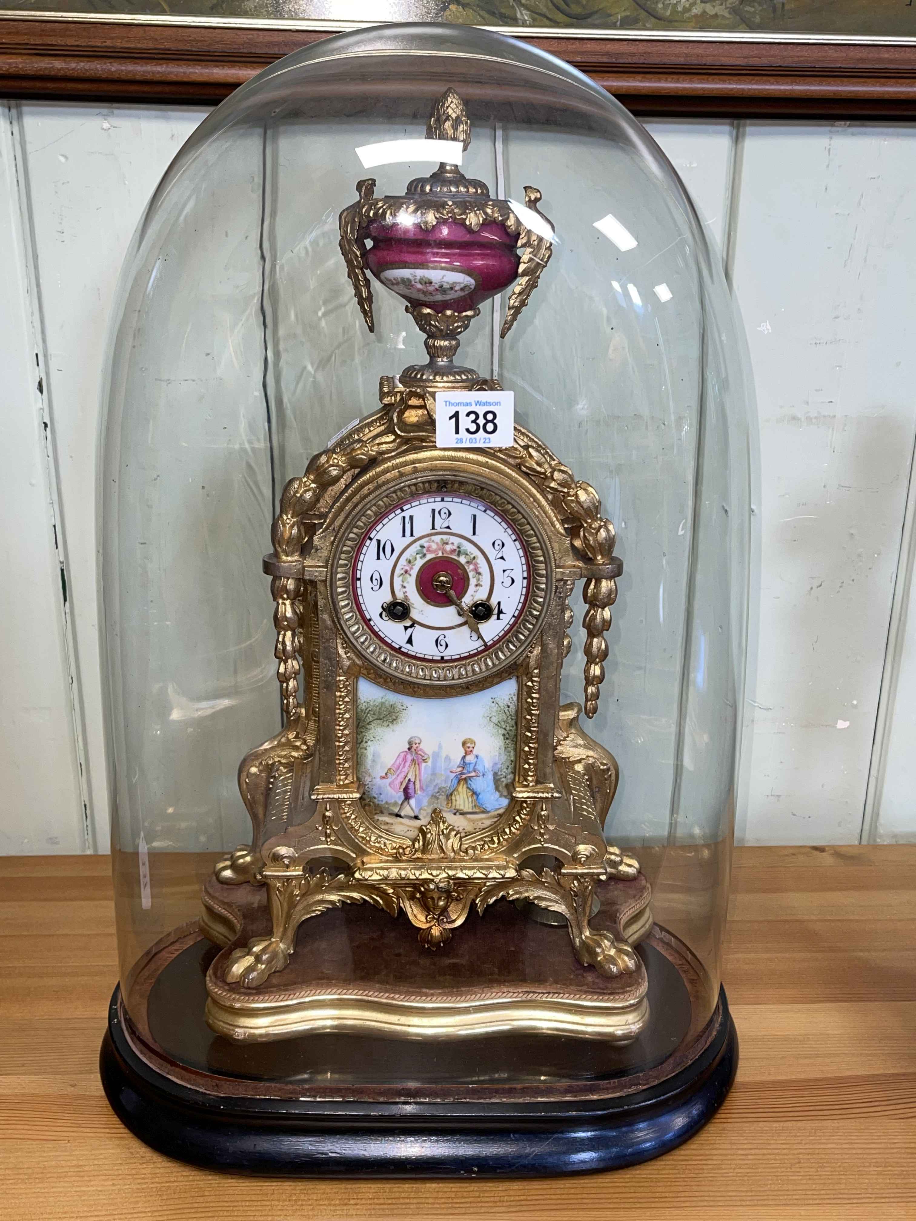 French ornate gilt metal mantel clock with enamel panel depicting classical scene below enamel dial