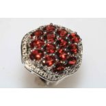 Silver garnet and white topaz limited edition ring, size P.