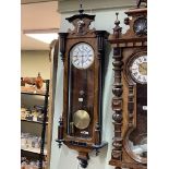 Victorian walnut and ebonised single weight Vienna style wall clock having enamelled dial, 125cm.
