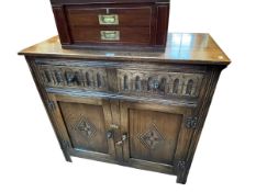 Carved oak two door side cabinet, 86cm by 91cm by 43cm.