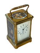 Gilt brass carriage clock with striking movement, 14cm.