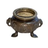 Oriental bronze censor with twin elephant mask handles decorated with bird and floral panels,