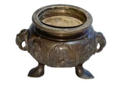 Oriental bronze censor with twin elephant mask handles decorated with bird and floral panels,