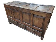Antique oak four panel front coffer with three base drawers, 77cm by 139cm by 52cm.