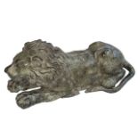 Hollow bronze sculpture of a recumbent lion, 26cm long.