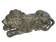 Hollow bronze sculpture of a recumbent lion, 26cm long.