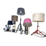 Collection of novelty table lamps and a fan including an iron, ceramic water bottle, tripod base,
