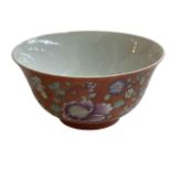 Chinese bowl with floral and famille rose design on orange ground, iron red stamp to base, 13cm.