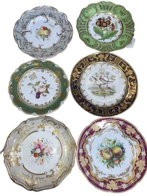 Seven assorted porcelain plates depicting flowers, fruit and birds.