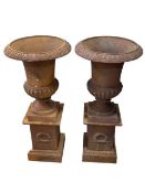 Pair cast rusted Campana style garden urns on pedestal bases, 75cm by 34cm diameter.